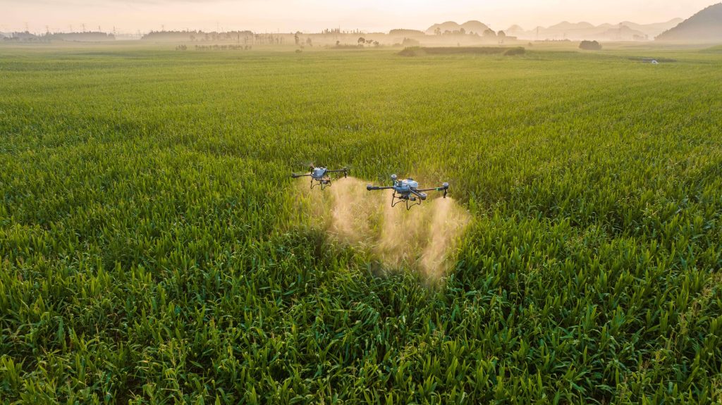 Agricultural drone flying over modern farmland for precision farming