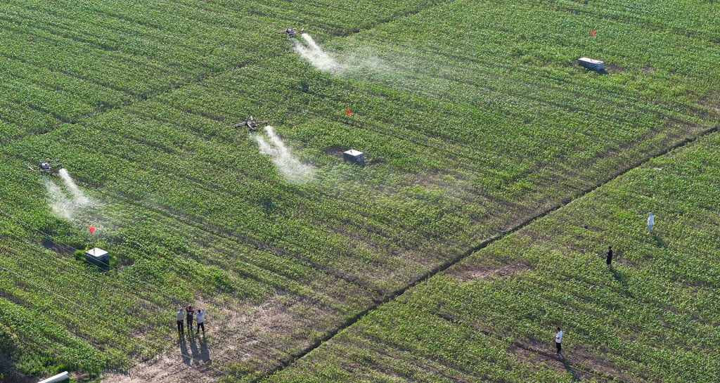 Agricultural drone performing variable rate spraying on crops