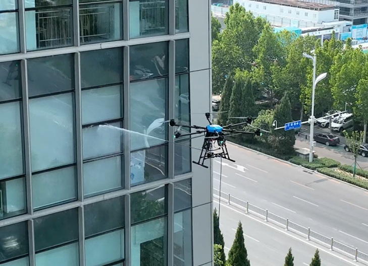 Tethered cleaning drone operating on a high-rise glass facade
